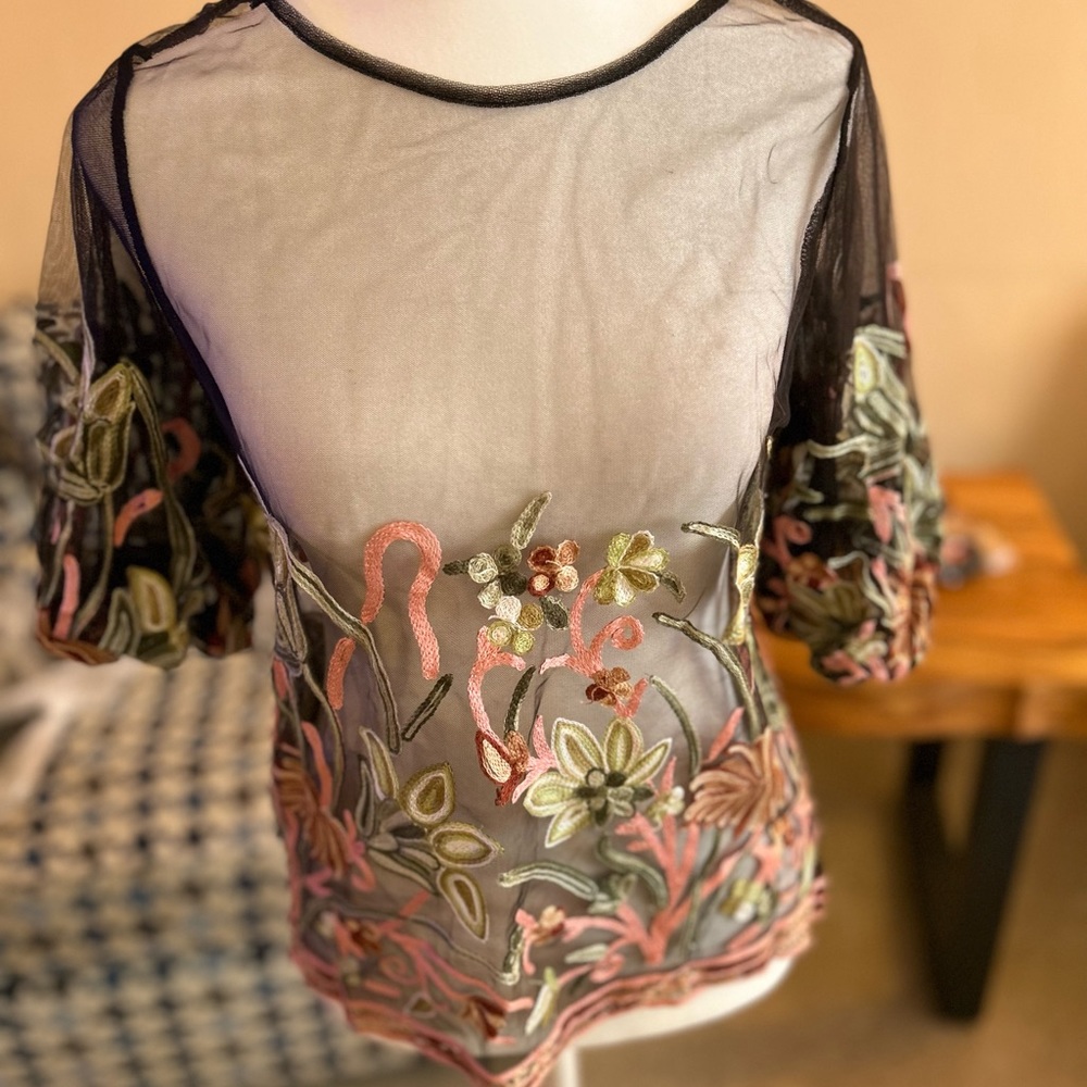 Gorgeous see-through top with flower detailing.